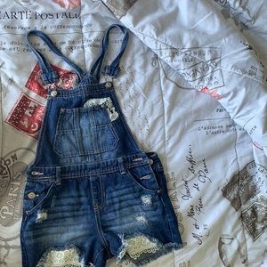 This is a blue Jean overall set for little girls.
